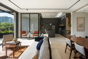 Modern living room with concrete flooring and minimalist furniture.