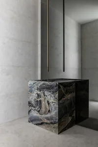 A minimalist modern interior featuring polished marble surfaces.