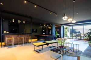 A stylish modern living room featuring a contemporary pool table, sleek furniture, and a minimalist design.