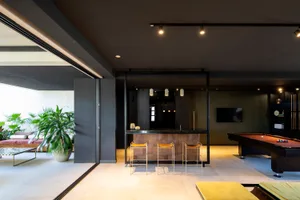 A modern living room features a combination of wood and stone materials.
