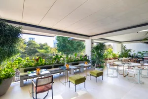 Modern patio with concrete surfaces and lush green plants