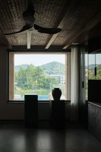 Minimalist residential interior featuring wood, glass, and concrete materials.
