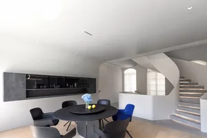 Modern interior design with concrete elements and minimalist furniture.