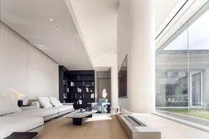 Modern living room featuring concrete, glass, and bamboo materials.