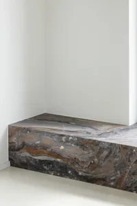 A minimalist room featuring a marble floor.