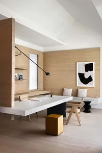 A modern office space featuring wooden walls and furniture.