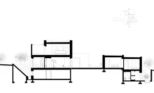 A modern kitchen with concrete finishes and minimalist design.