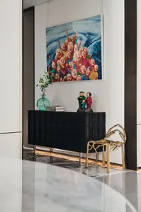 Modern lounge area with metal, glass, and wooden furnishings and decorative elements.