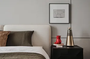 Minimalist bedroom with a bed featuring a white upholstered headboard, brown and beige textured bedding, and a wooden bedside