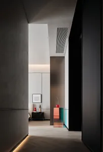 A minimalist bedroom with concrete and glass elements.