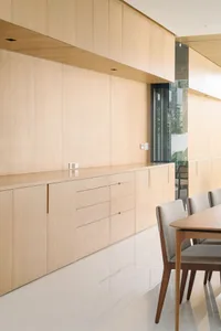 Modern kitchen with wooden cabinets and white flooring