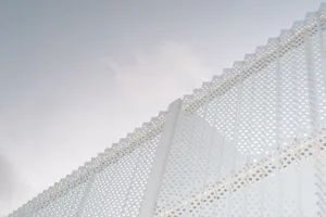 Modern minimalist building with perforated metal facade