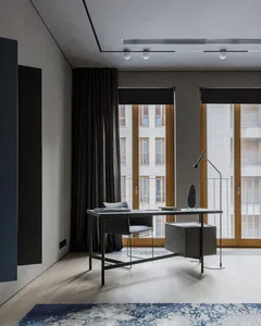 Modern office space featuring wooden flooring, minimalistic furniture, and large windows.