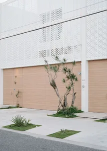 Modern residential exterior with garage doors and minimalist design elements.