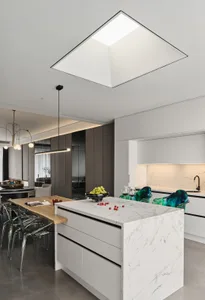 Modern residential kitchen featuring white marble countertops, glass cabinets, and wooden island.