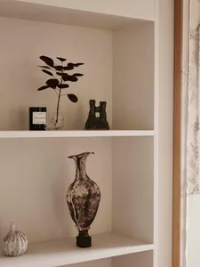Ceramic vases on a shelf in an interior design setting