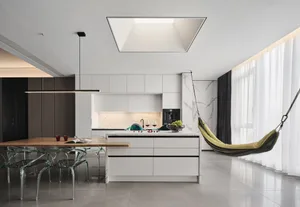 A modern residential kitchen with a marble countertop and island.