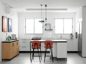 Contemporary kitchen with white tiled counters and concrete flooring.