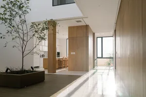Modern minimalist interior with wooden walls, glass doors, and concrete elements