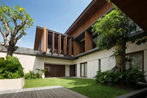 A modern residential space featuring wood, concrete, and glass materials.