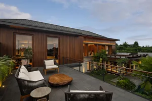 Modern patio with wood deck, concrete floor, and potted plants