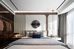 A modern bedroom featuring fabric bedding, metal accents, and wooden elements.