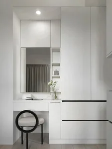 Modern interior design featuring minimalist white cabinets and ceramic tile flooring.