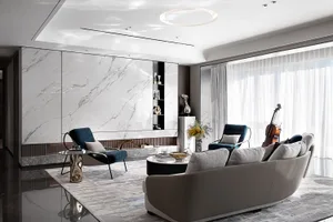 Modern living room featuring marble walls, leather furniture, and glass decor.