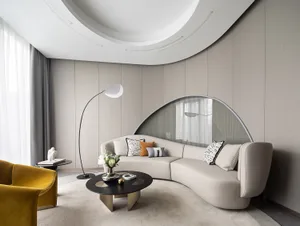 Modern living room featuring a neutral-color leather sofa, round coffee table, and a unique round window.