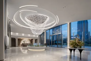 Modern lobby interior with glass chandelier and sleek, minimalist design