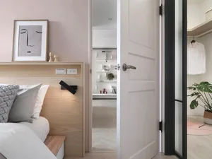 Modern minimalist bedroom featuring wood accents and laminate flooring