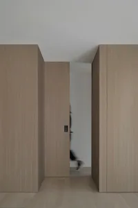 A modern minimalist living space featuring wooden cabinets