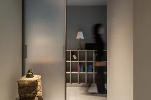 A minimalist home library featuring a metallic shelf.