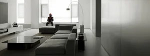 A modern minimalist living room with a large sectional sofa, sleek coffee table, and minimalist décor.