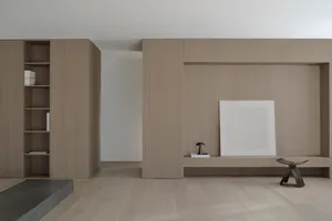 Minimalist living room featuring wooden walls, concrete floor, and sleek furniture.