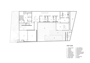 Floor plan of a modern residential building with a first floor featuring multiple rooms including bedrooms, bathrooms, and a 