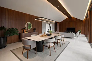 A modern residential interior featuring wood, marble, and fabric materials.