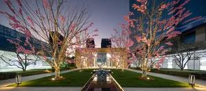 A beautifully lit architectural landscape with cherry blossom trees.