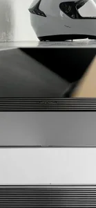 A minimalist electronic device with a black body and a metallic white section.