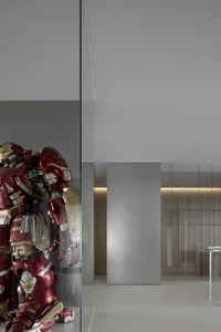 A minimalist interior with a metallic Hulkbuster sculpture.