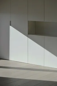 Minimalist white interior featuring white wooden flooring.