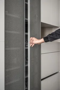 A modern metallic pierced wardrobe with a sleek, industrial look.