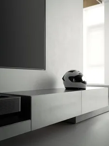 A sleek, minimalist living room with a concrete finish.