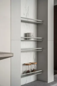 A modern minimalist kitchen with sleek, white marble countertops and shelves.