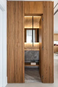 Modern bathroom with marble and wood finishes, featuring a sleek, minimalist design.