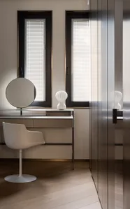 A modern interior with sleek, white chairs on a polished concrete floor and metallic furniture.