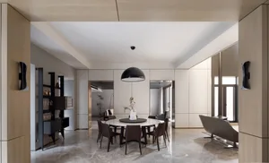 A modern living room featuring a minimalist design with a concrete floor and wall.