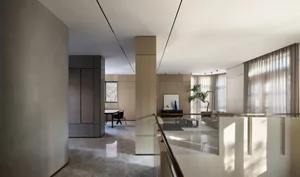 Contemporary living room with sleek, modern design featuring solid marble floors and a wooden sofa.