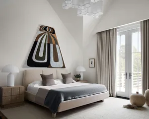 Modern minimalist bedroom featuring a comfortable bed with plush textiles and elegant decor.