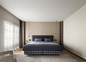 A modern bedroom with neutral color palette and textile accents.